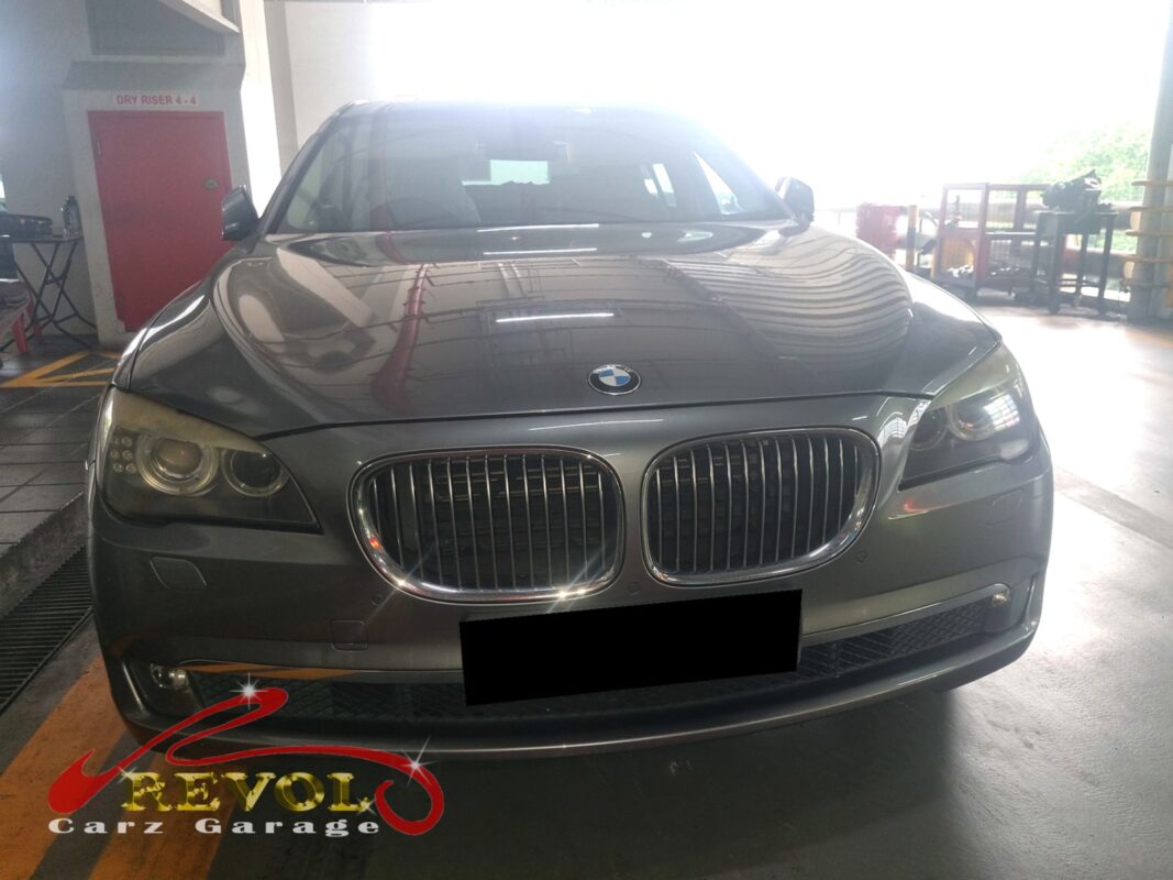 BMW 730Li on the workshop lift with the gearbox separated for rear main seal access.