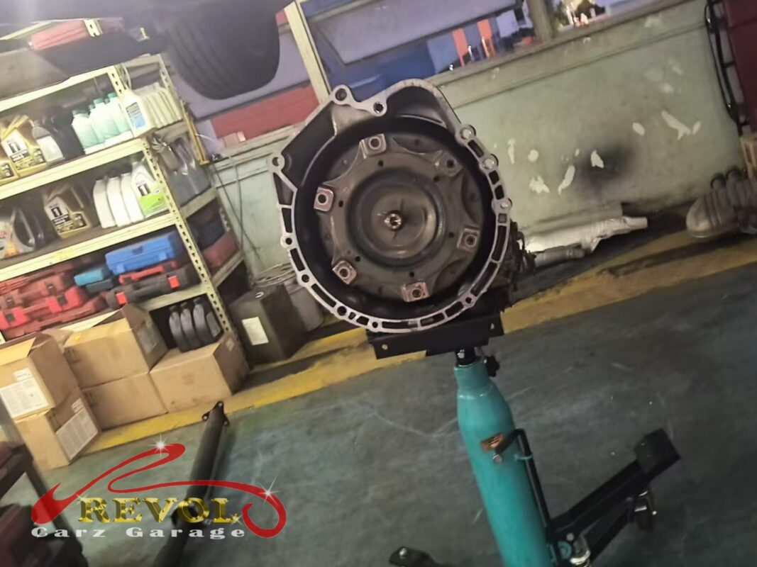 The transmission out and supported on the jack, separated from the engine to reach the seal.