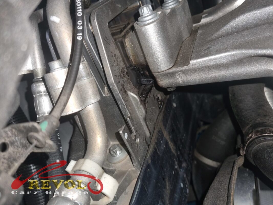 One of the engine mounts in the bay, the rubber split and seeping fluid.