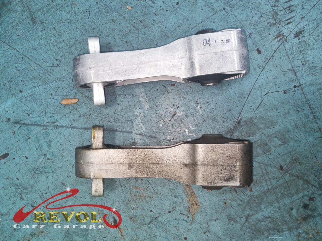 The lower torque strut, the worn one (bottom) beside the new BMW-spec replacement (top).