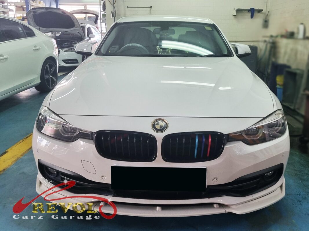 BMW 318i on the workshop lift for ATF service.
