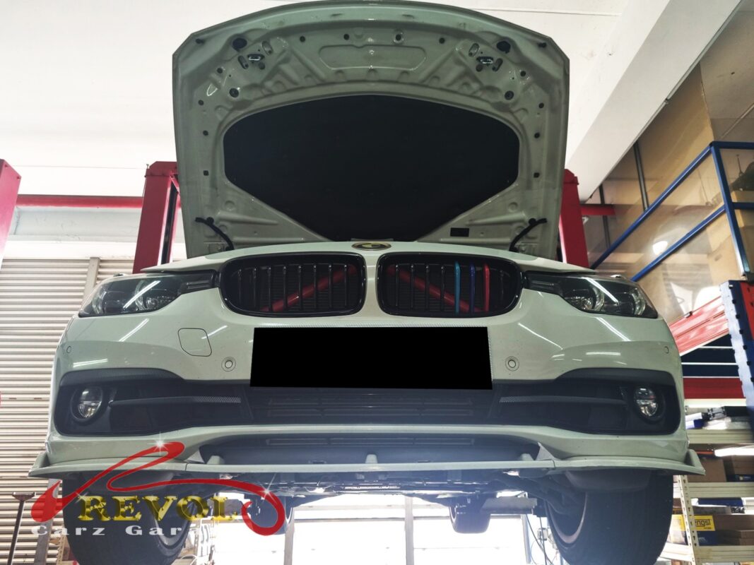 The 318i up on the two-post lift, in for its scheduled ATF service.