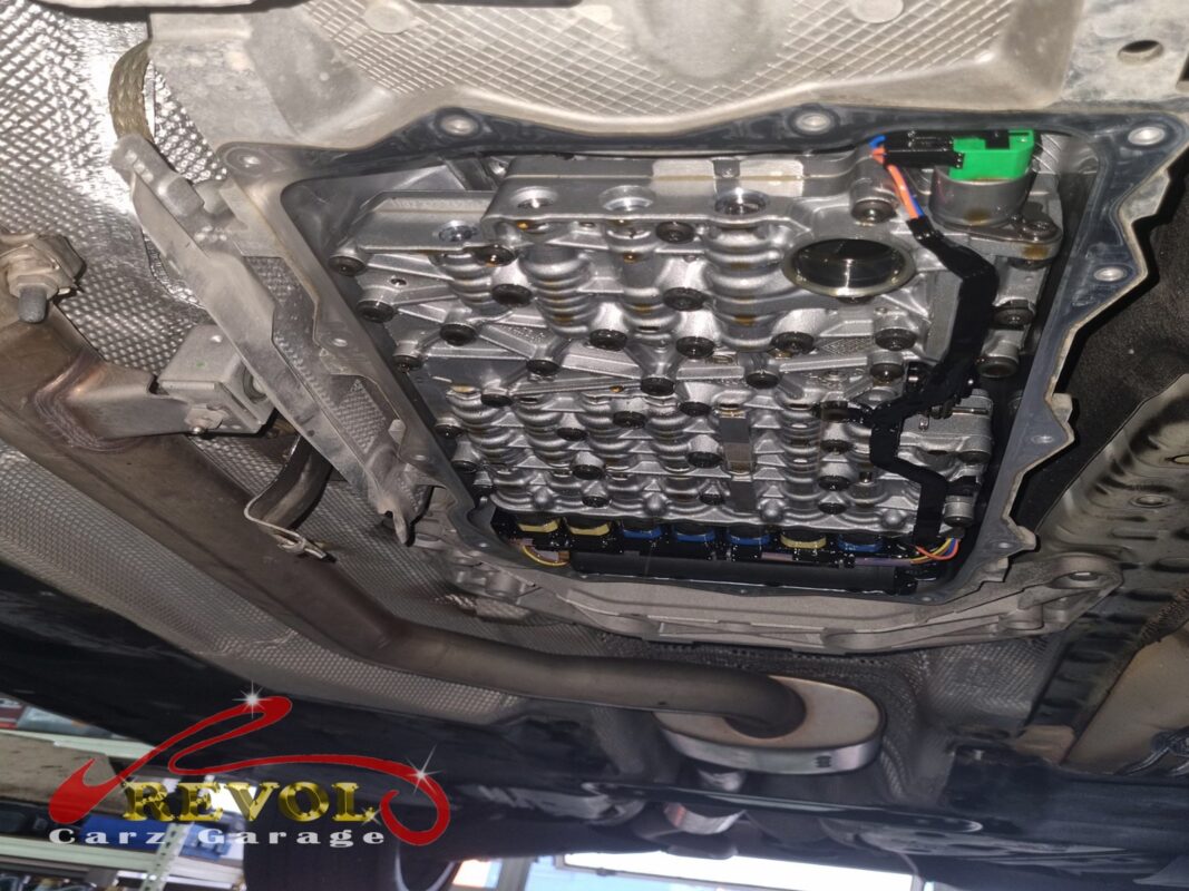 The gearbox pan dropped, the valve body and solenoids exposed for the fluid and filter service.