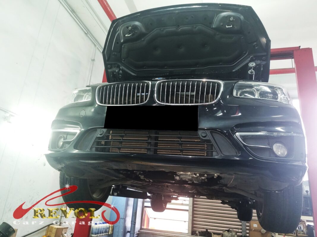 The 216d up on the two-post lift, in for the oil leak.