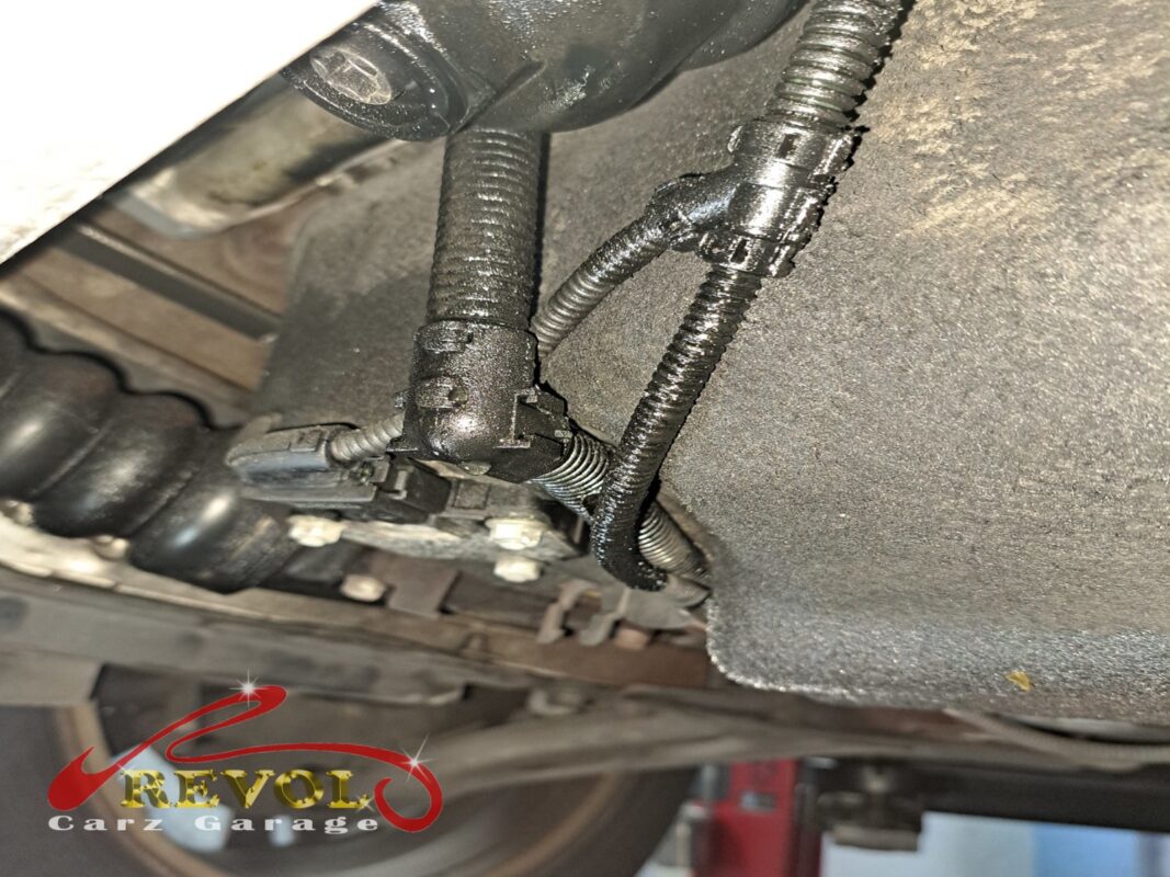 Underneath the 216d, oil traces tracking down from the filter housing area.