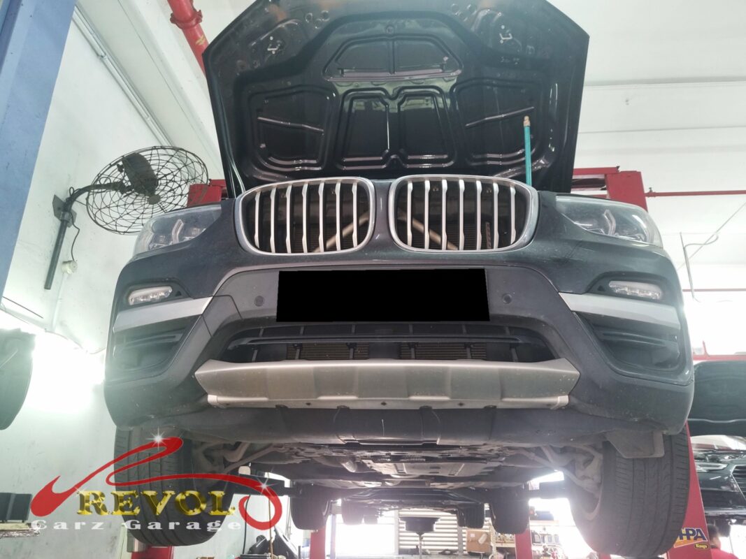 The X3 up on the two-post lift, in for the coolant leak.