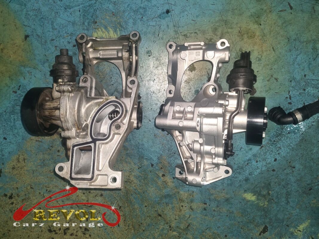 The old water pump and housing (left, grimy) beside the new BMW-spec module (right).