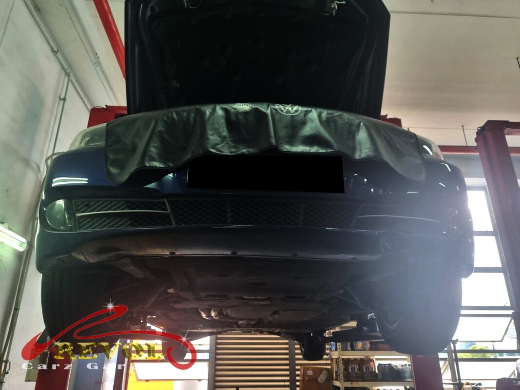 The 523i up on the two-post lift, in for the front-end inspection.