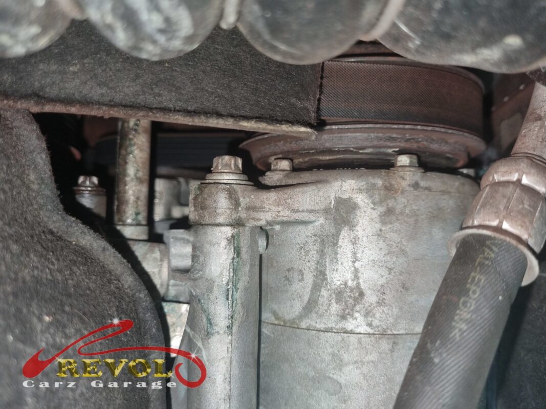 The accessory belt drive at the front of the engine, the crankshaft pulley running the belt.