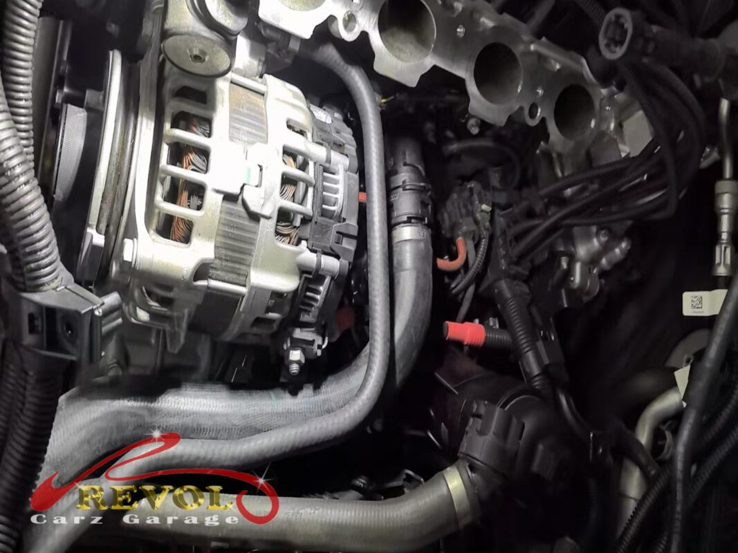 The water pump area opened up, the alternator and coolant lines around it.