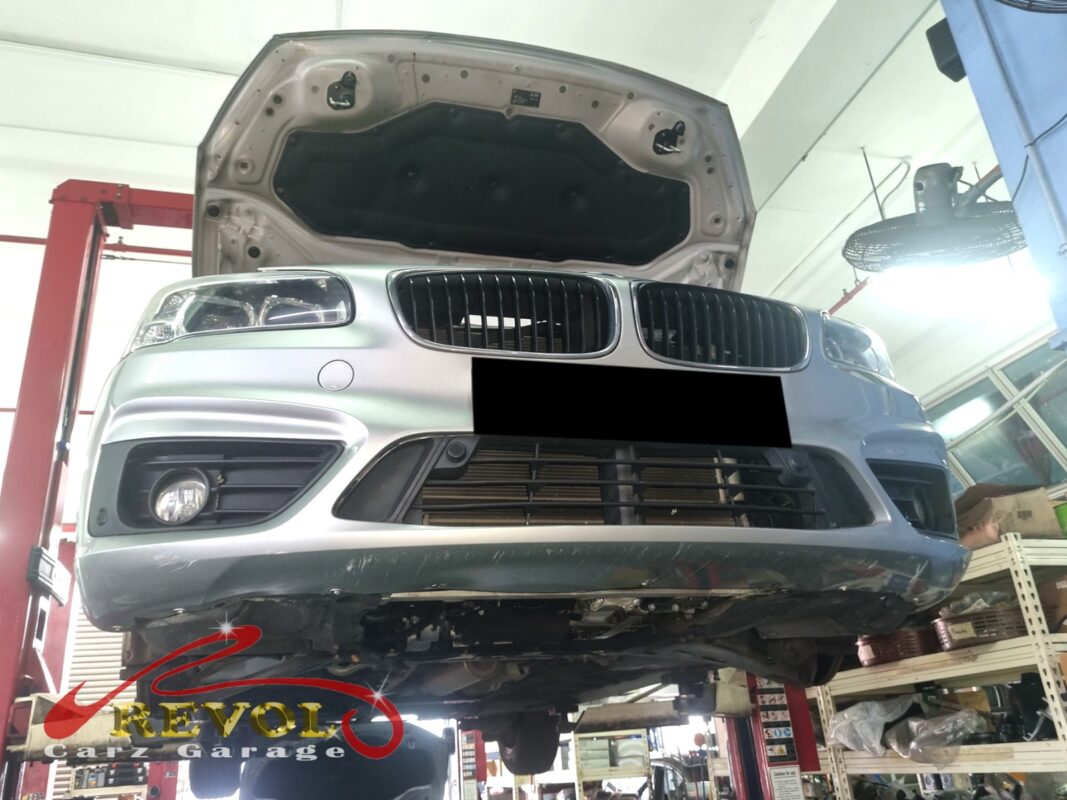 The 218i up on the two-post lift, in for the coolant leak.