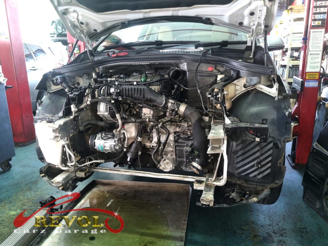 The front of the 218i opened up, the bumper off and the cooling stack exposed for the radiator job.