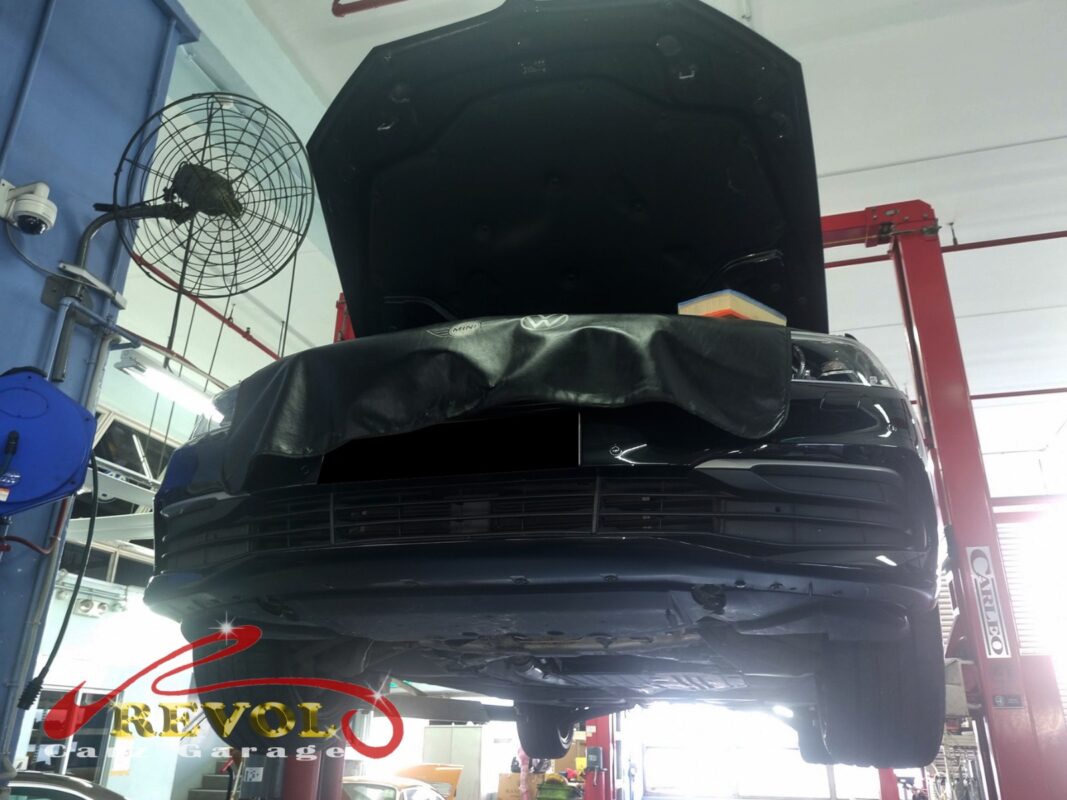 The 530i up on the two-post lift, in for the front control arms.