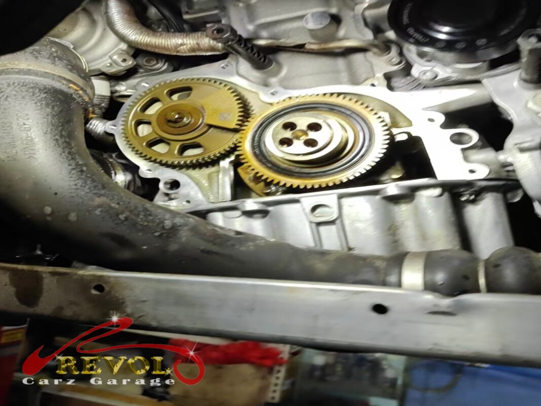 The timing cover off, the timing drive at the front of the engine exposed.