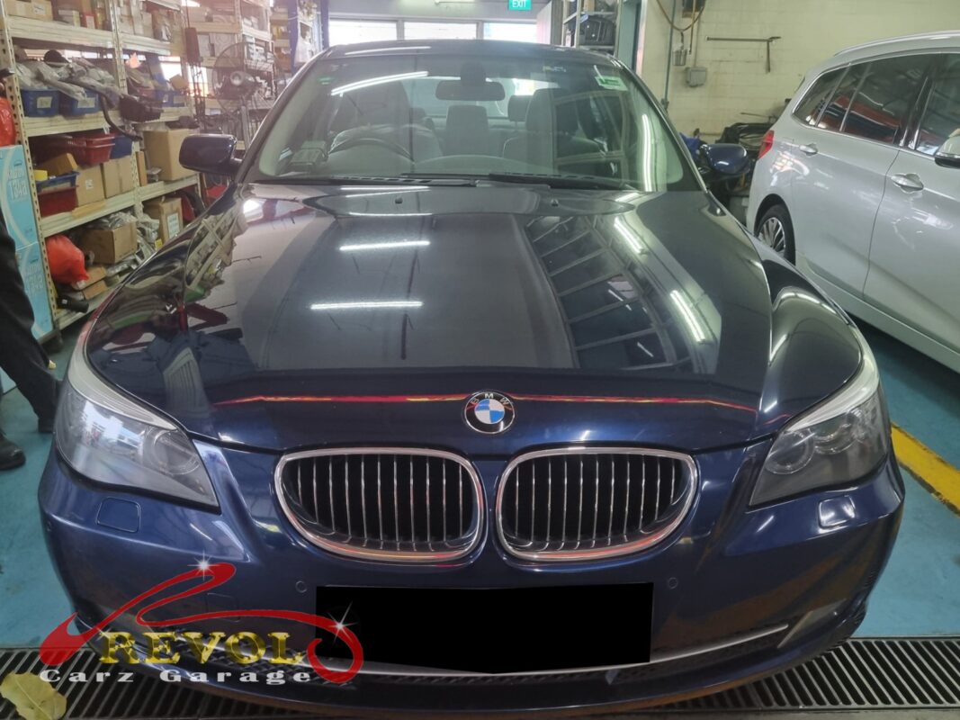 BMW 216d with the engine cover off for valve cover replacement.