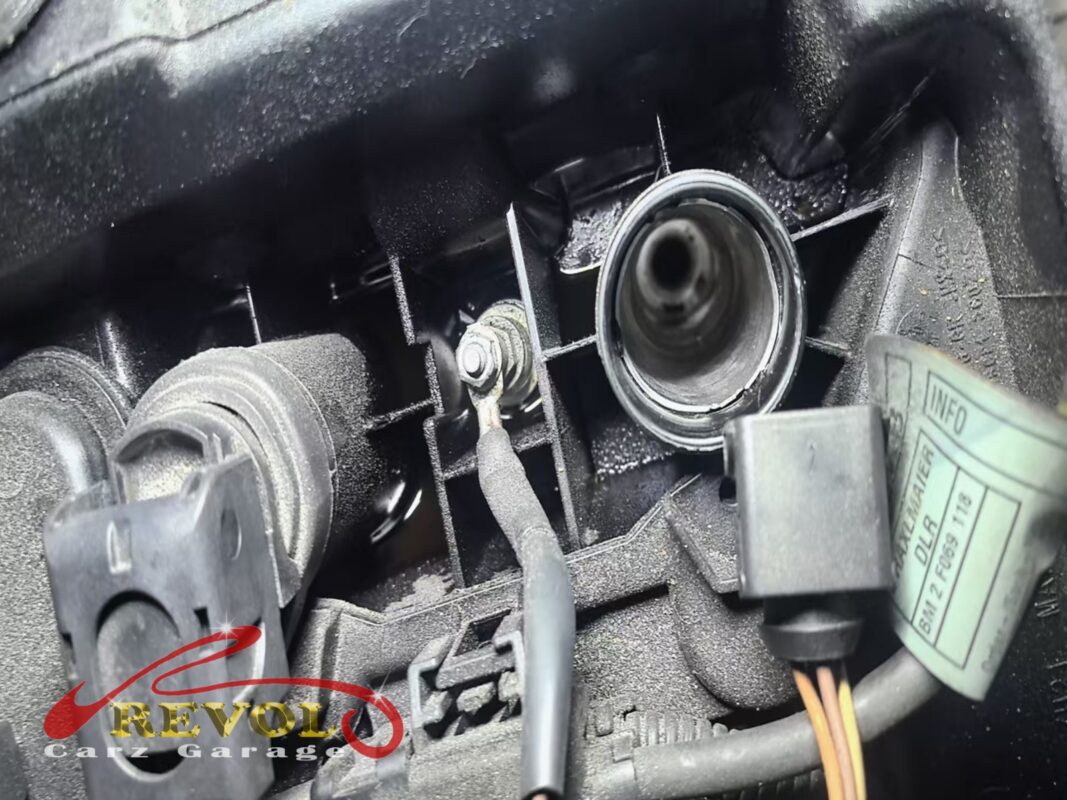 Oil pooled in one of the plug wells, soaked into the coil boot, the cause of the misfire.