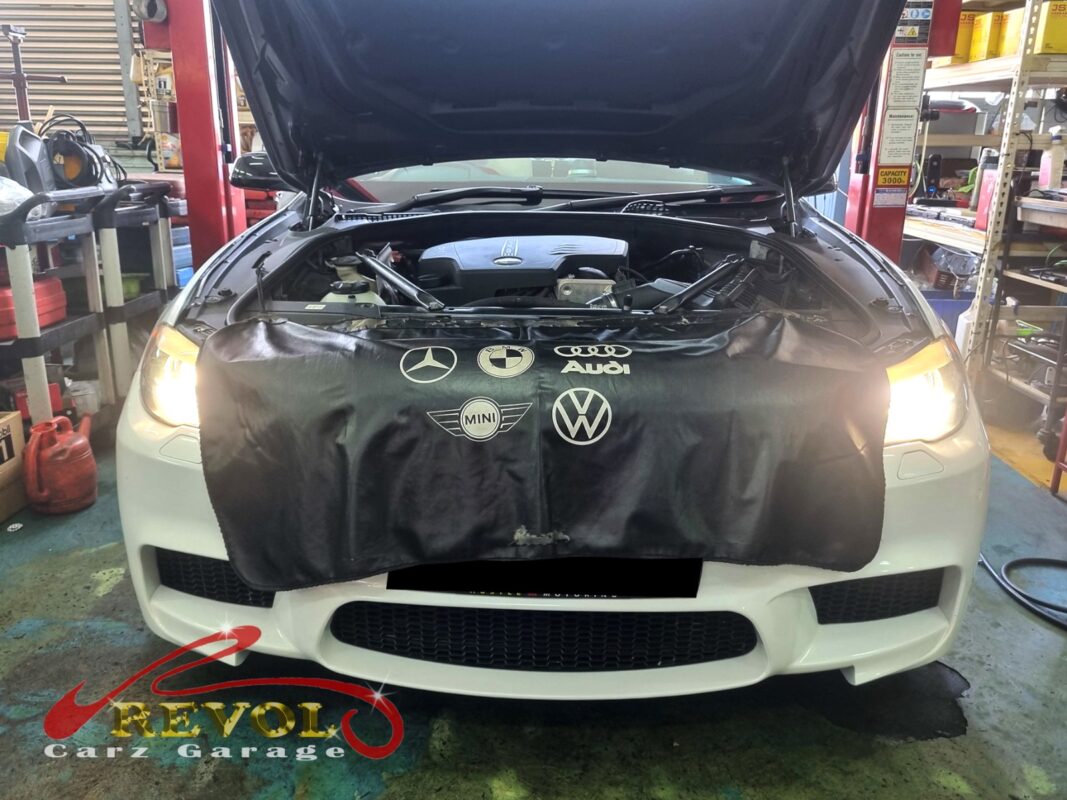 BMW 528i on the workshop lift for fan belt set replacement.