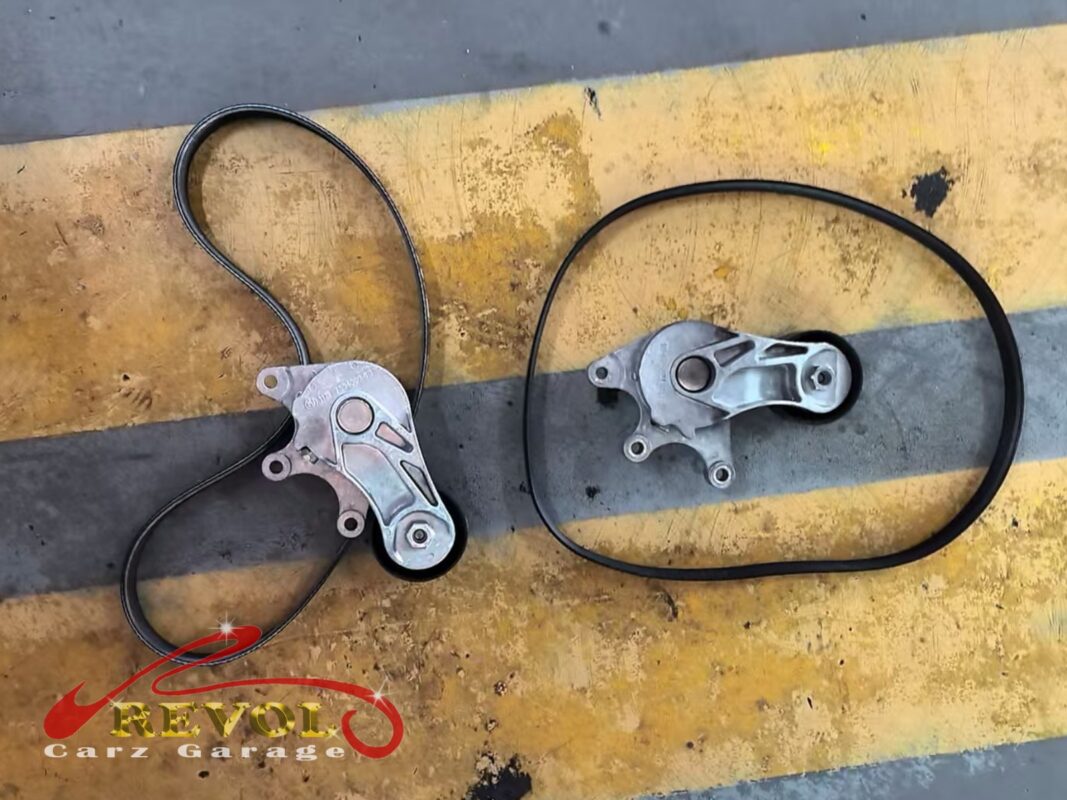 The old belt and tensioner (left) beside the new BMW-spec belt and tensioner (right).