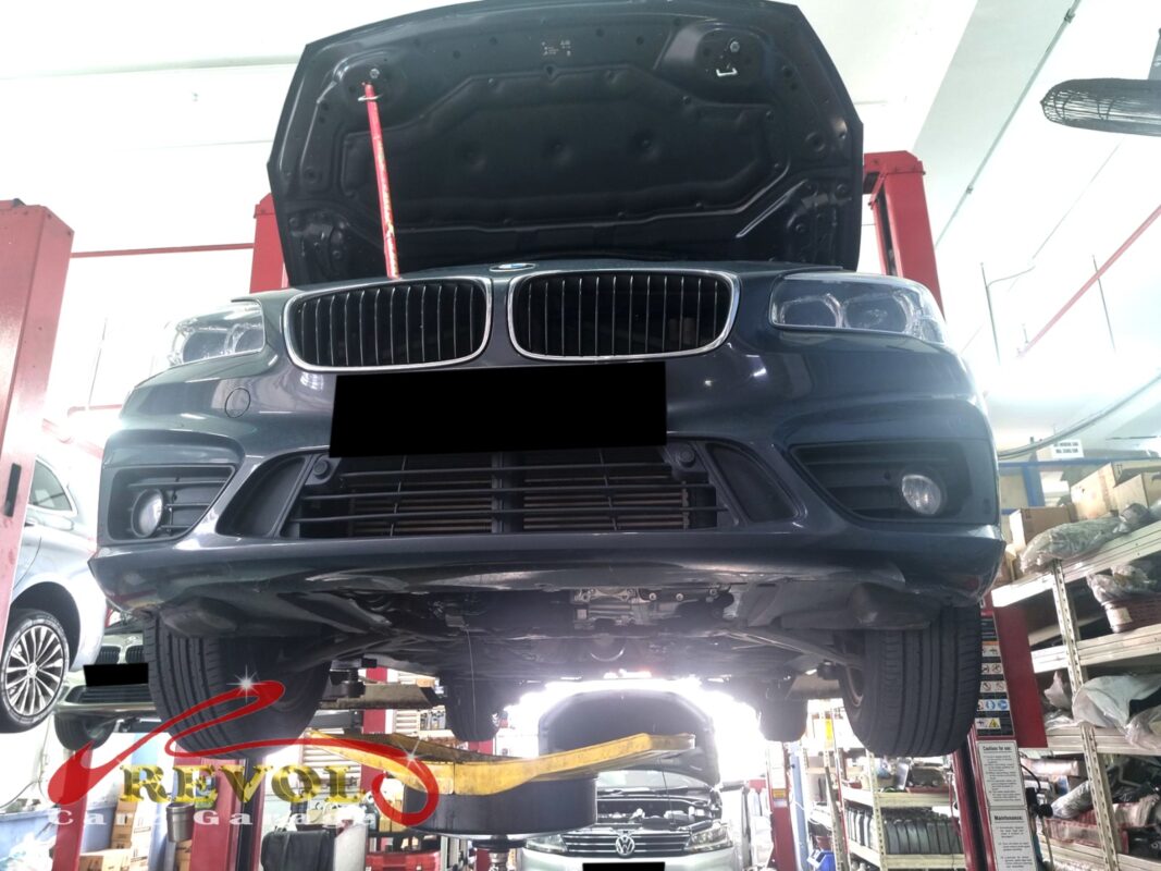 The 216d up on the two-post lift, in for the engine rattle.
