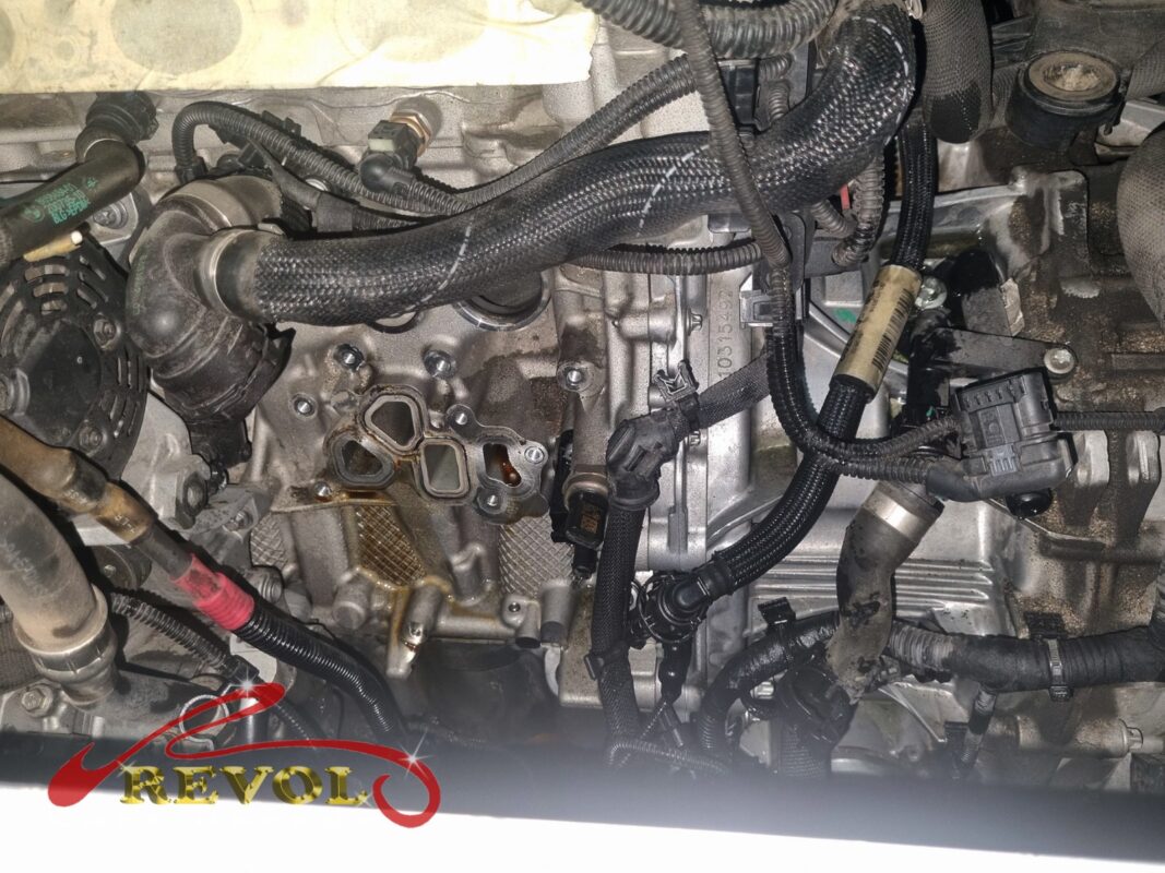 The thermostat housing removed, the mounting face on the engine exposed.