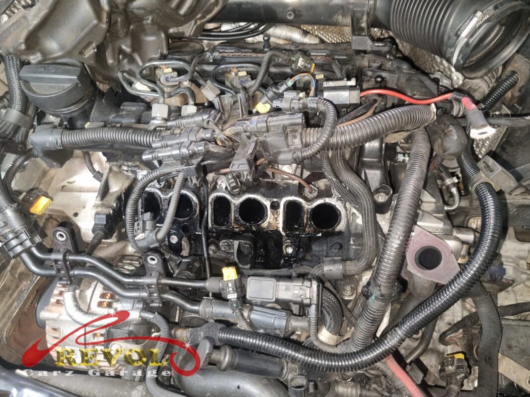 The intake manifold off, the cylinder head intake ports exposed, sooty with the usual diesel carbon.