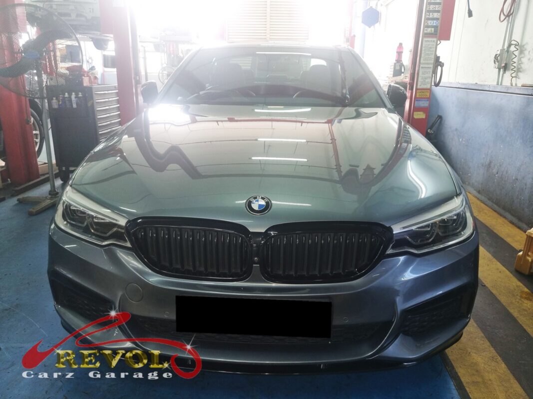 BMW 530i with the engine cover off for valve cover replacement.