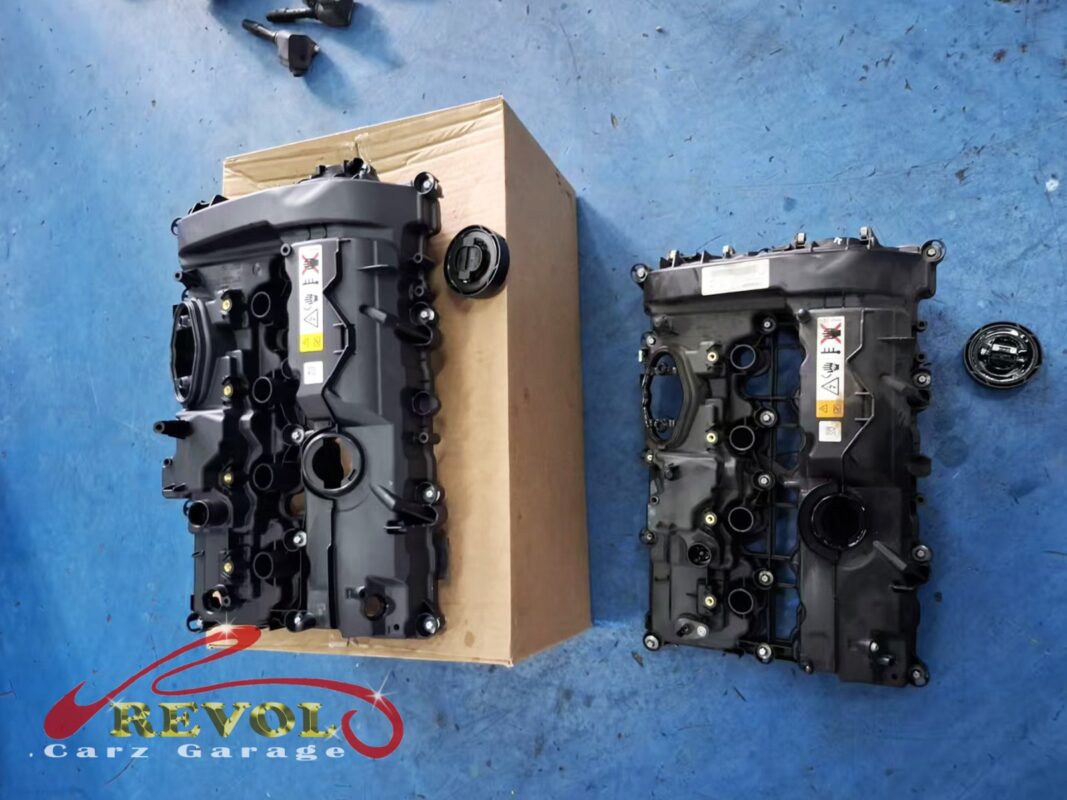 The old valve cover (right) beside the new BMW-spec cover with its integrated gasket (left).