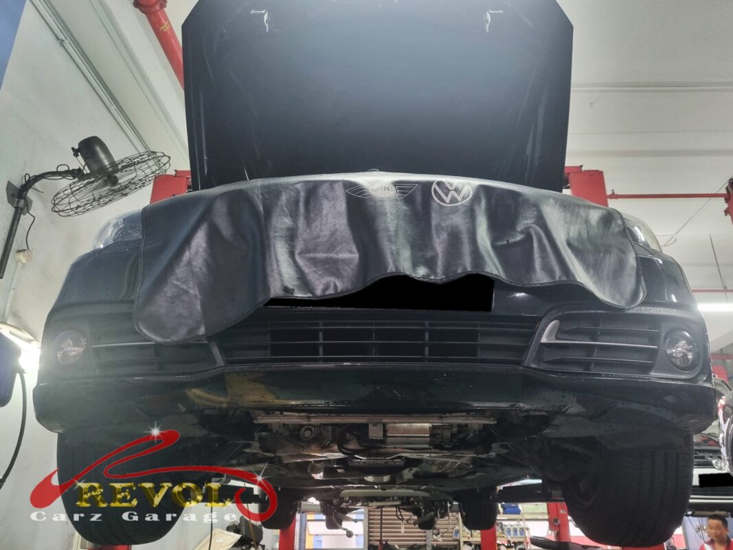 The 520i up on the two-post lift, in for the oil leak.