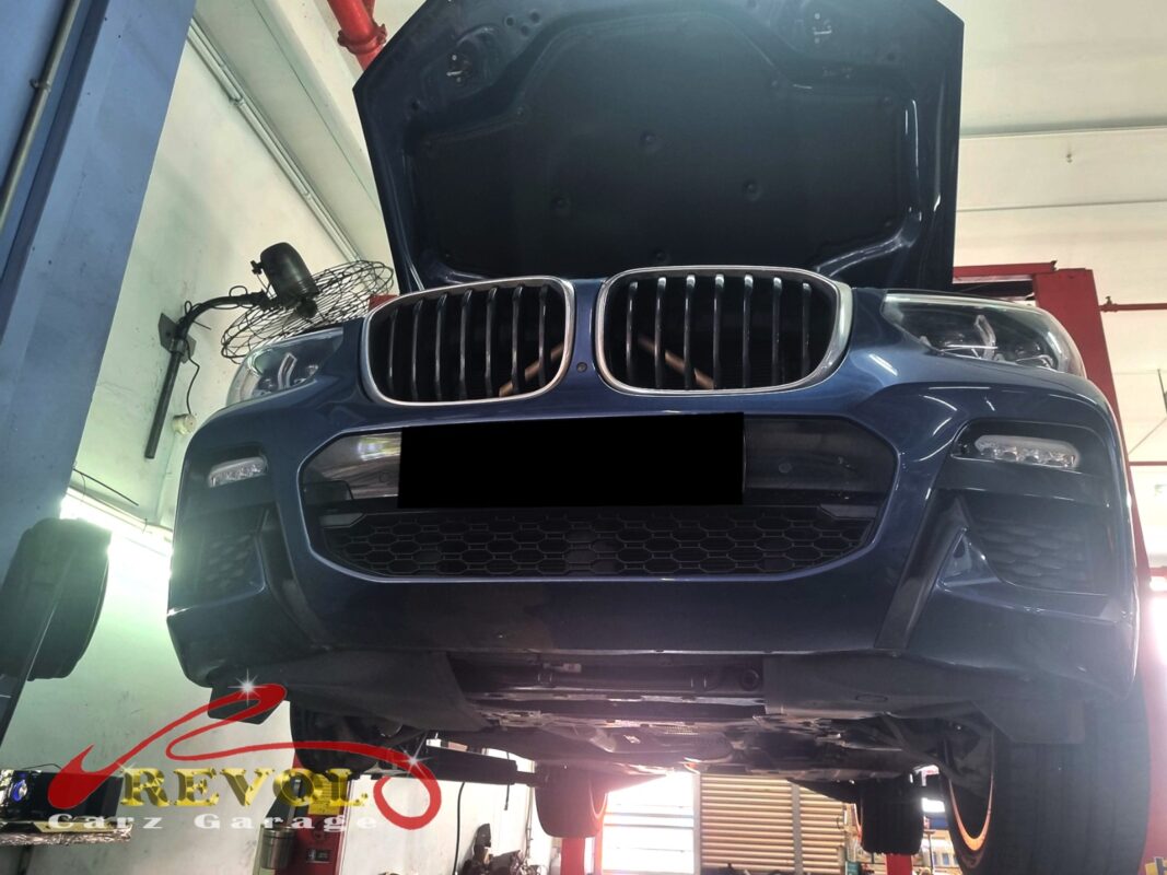 The X3 up on the two-post lift, in for the coolant leak.