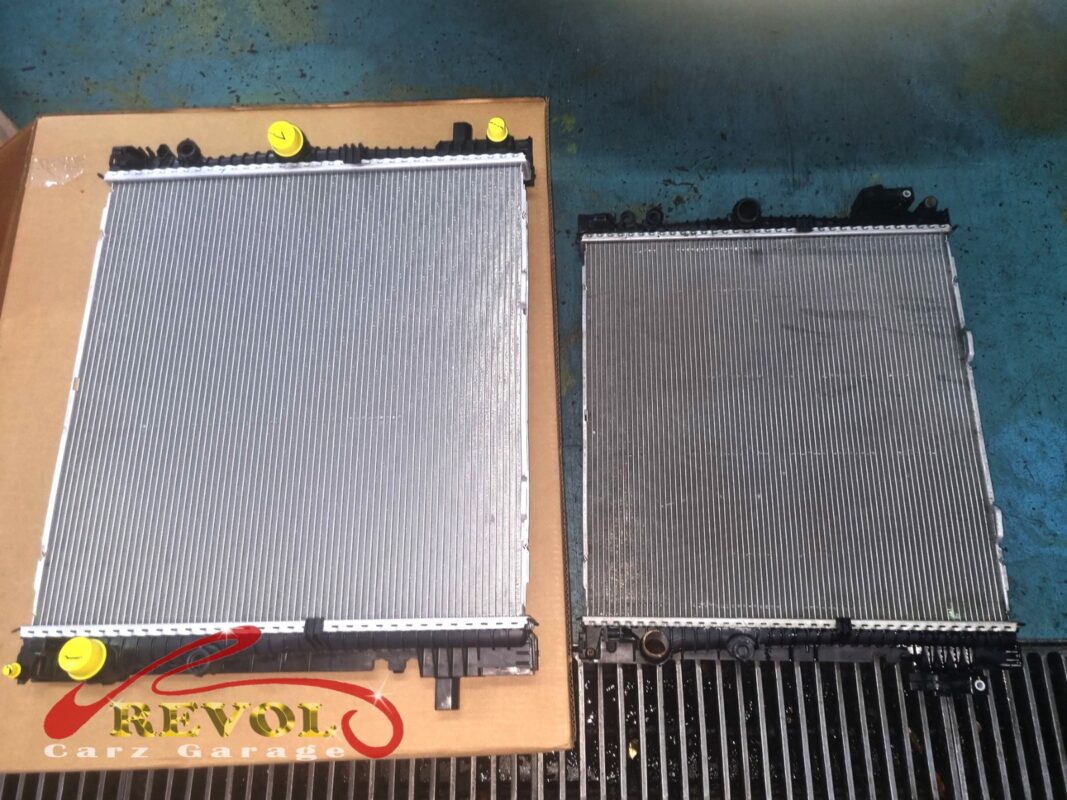 The new BMW-spec radiator (left) beside the old one removed (right).