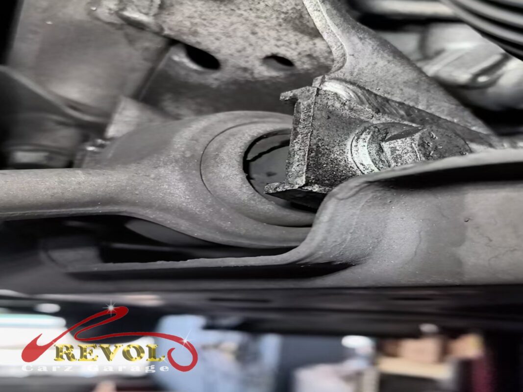 A front control arm bushing on the car, the rubber deflecting past spec, the slack behind the knock.