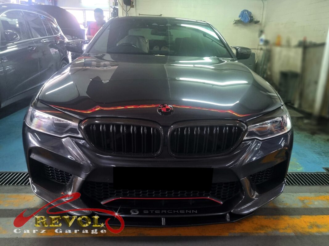 BMW 530i on the workshop lift for full scheduled servicing.