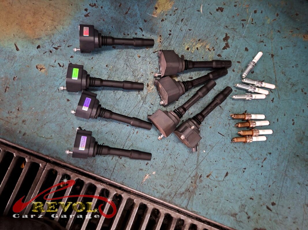The new ignition coils and spark plugs (left) beside the old worn ones (right).