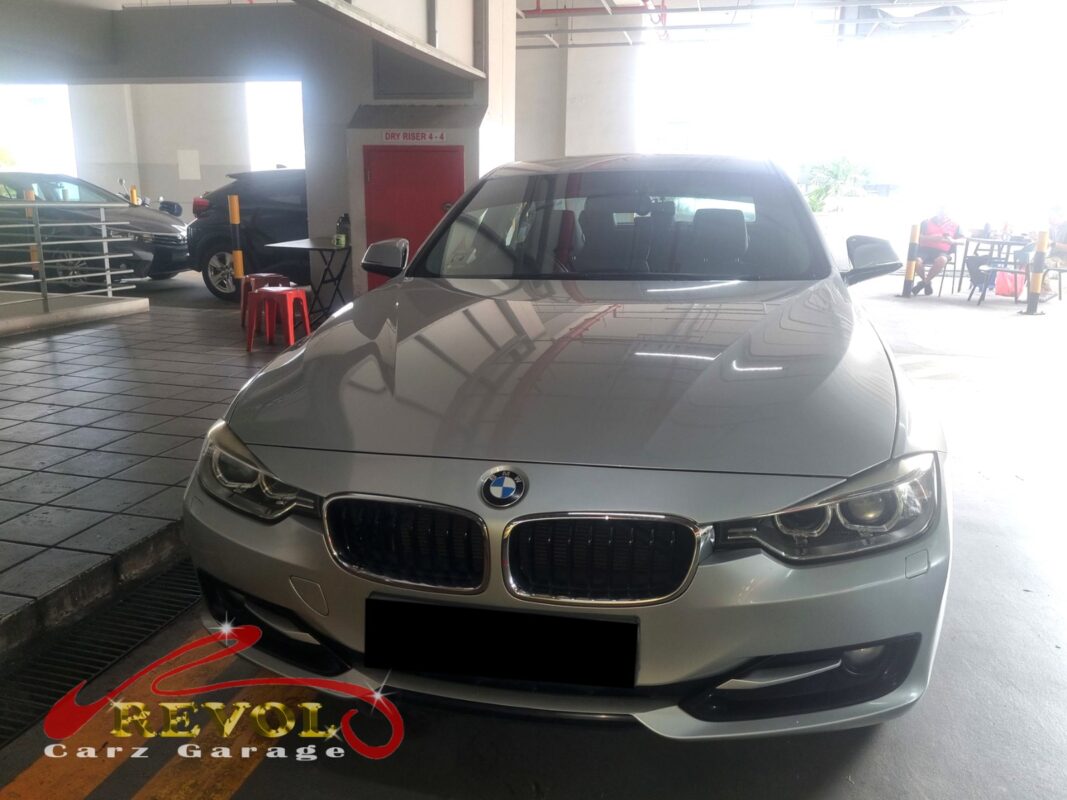BMW 316i at the Revol Carz workshop, up on the lift for the rear main oil seal job.