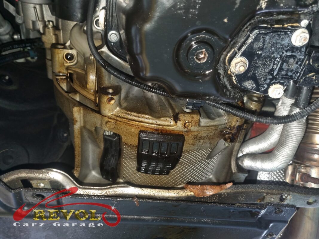 The gearbox supported on a transmission jack, ready to be drawn back off the engine.