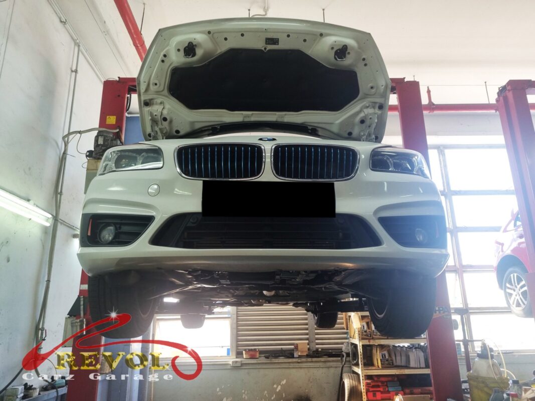 The 225xe up on the two-post lift, in for the oil leak.