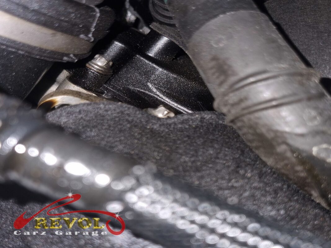 Oil tracking down from the timing cover area at the front of the engine.