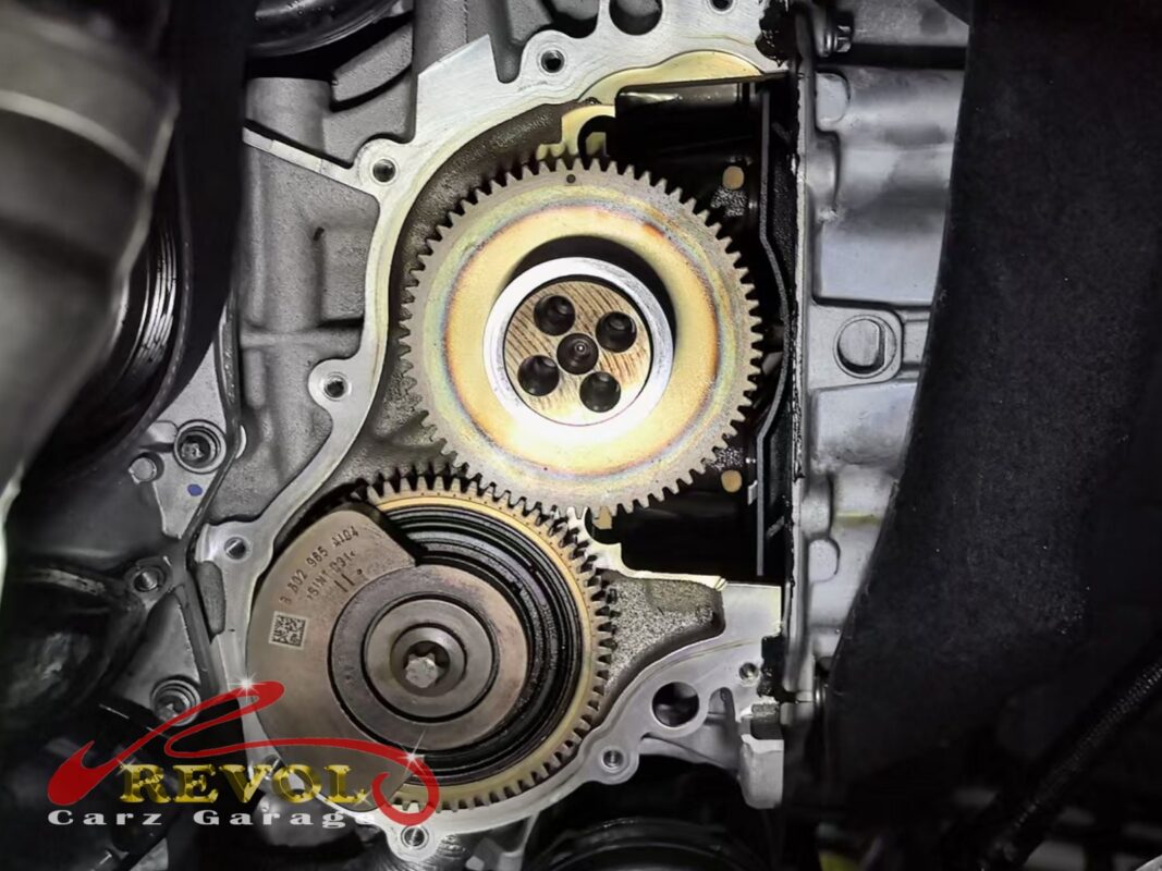 The timing cover off, the timing drive gears at the front of the engine exposed.