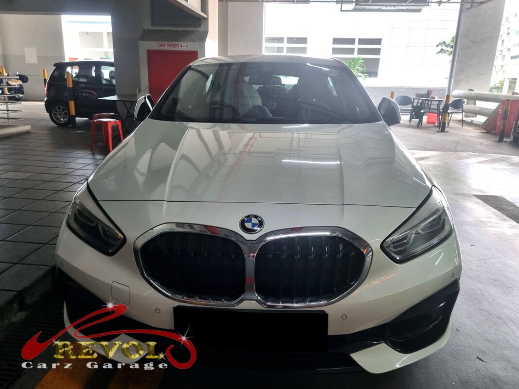 BMW 116i on the workshop lift for diagnosis of a persistent check engine light.