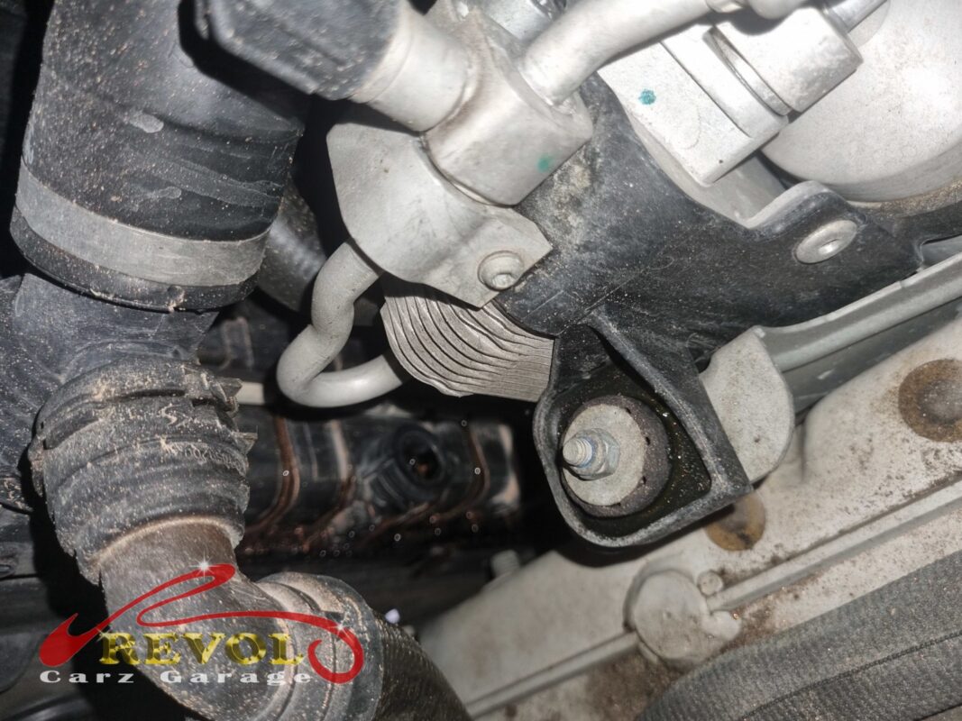 The cooling-system plumbing at the front of the engine, traced for the source of the leak.
