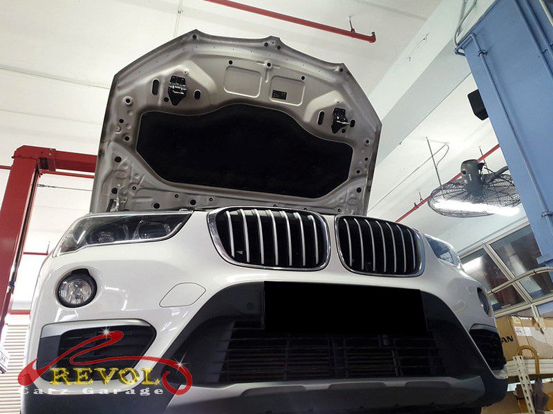 The oil level and condition checked on the BMW X1, confirming it was full and clean.