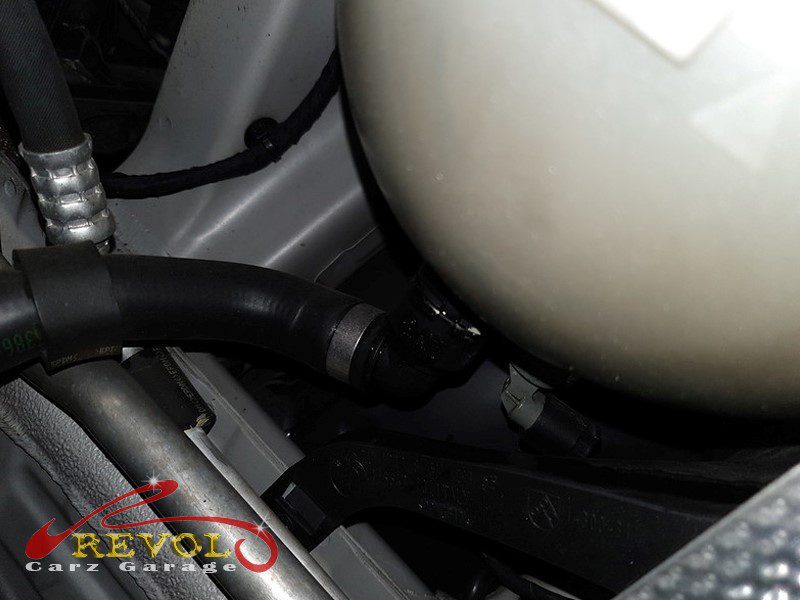 The cracked plastic coolant expansion tank found weeping under pressure.