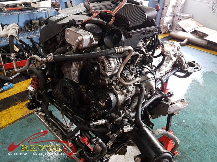 The N55 engine being brought down out of the X5.