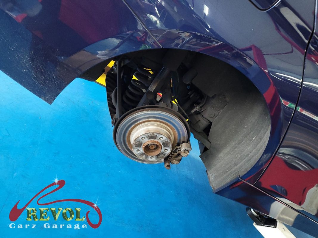 The worn front pads and scored disc, the wear sensor ground through.