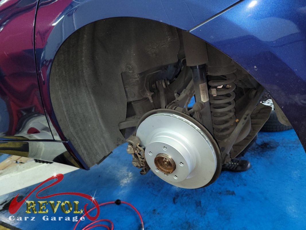 The new front brakes installed and the calipers serviced.