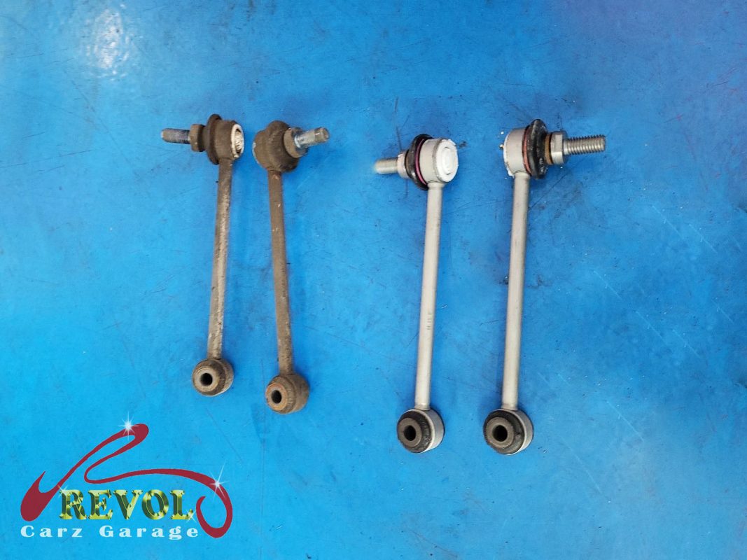 The old rear shocks removed alongside the new pair.
