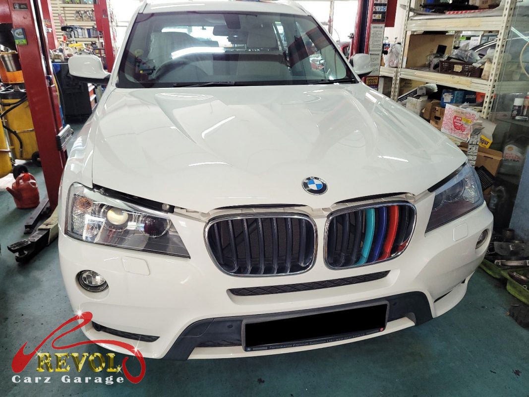 BMW X3 parked at the workshop for maintenance servicing.