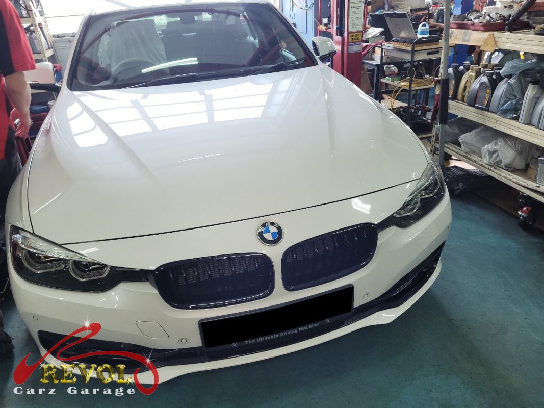BMW 318i parked at the workshop for scheduled maintenance servicing.