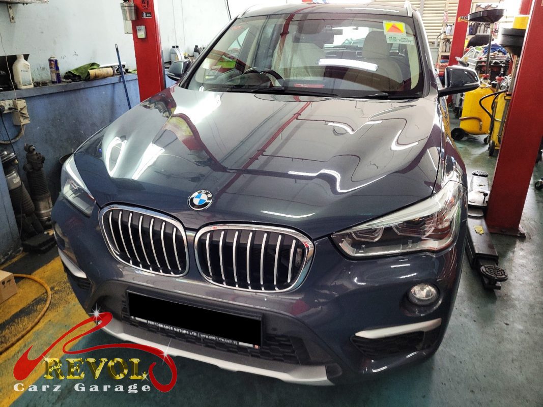 BMW X1 parked at the workshop, in for engine and gearbox mount replacement.