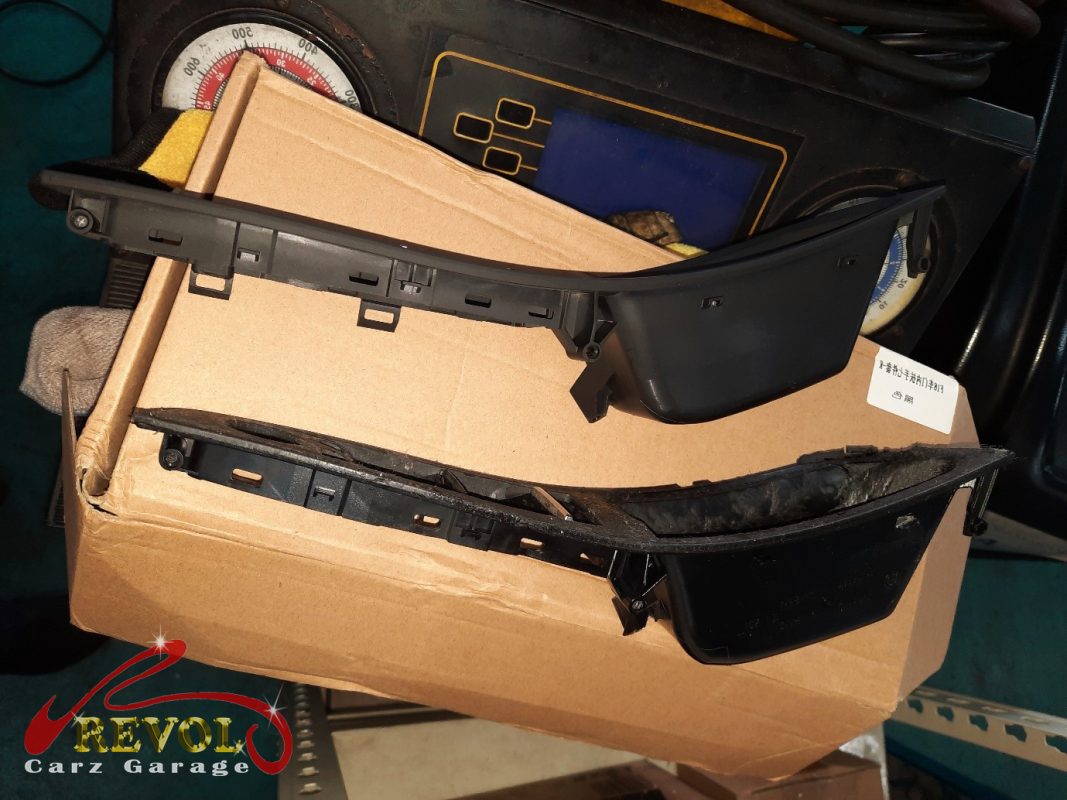 The old worn door handle assembly with cracked levers removed.